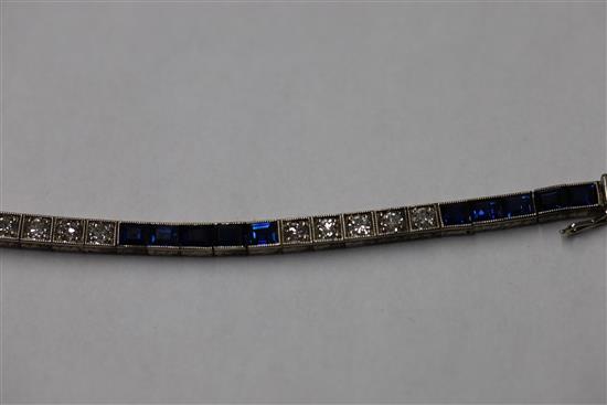 A 1920s 18ct white gold, sapphire and diamond set line bracelet, in original fitted Charles Packer & Co Ltd box.